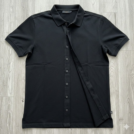 Black short-sleeve shirt on a wooden surface